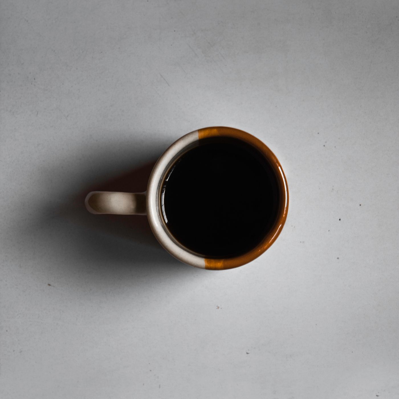 A ceramic mug photographed from directly above on a plain background.